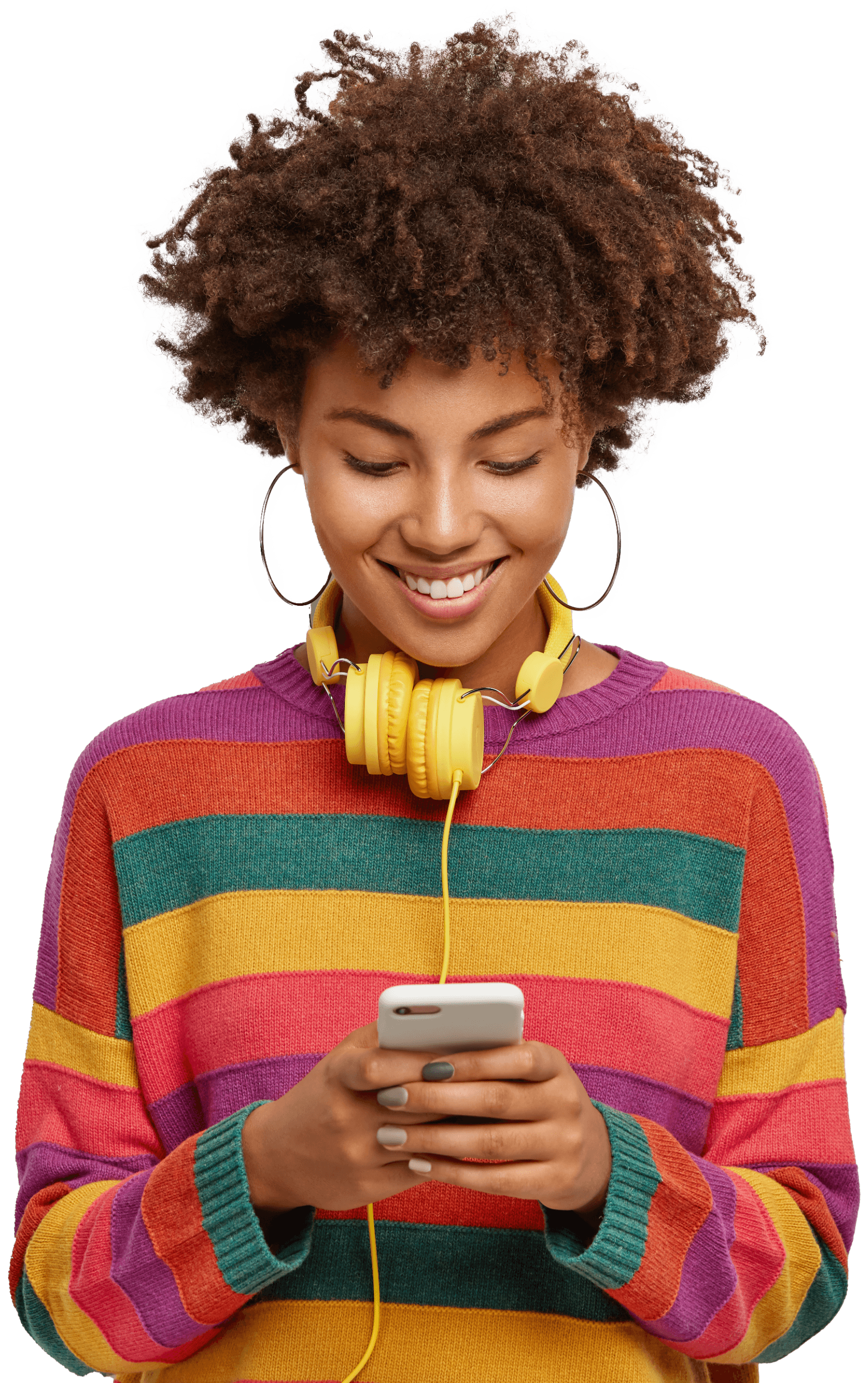 Woman smiling at her phone with headphones around her neck